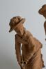 &lsquo;Cricket & Croquet&rsquo;. A unusual pair of nineteenth century unglazed terracotta earthenware figures. One of a boy batsmen, wearing broad banded boater, wearing pads and with bat and stance ready to receive the ball and the other of a young woman wearing dre - 3