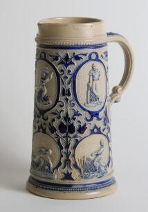 Westerwald cricket jug. Large and very attractive Westerwald cobalt blue stoneware cricket jug, moulded in relief with six cameo panels of a batsman, fielder and wicket-keeper, believed to be W.G. Grace, in different cricketing poses. plus two smaller cam