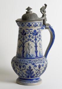 Westerwald. Large and impressive Westerwald stoneware tapering cricket jug, moulded in relief with five cameo panels all believed to be modelled on W.G. Grace, in different poses, coloured in cobalt blue on a grey background. The body decorated with vine 