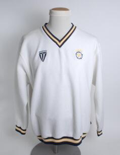 Hampshire white 1st XI long sleeved fleece overtop/sweater with trimming to collar, waist and cuffs in club colours, Hampshire emblem and sponsors logo &lsquo;Fearnley&rsquo; to chest. Size &lsquo;Large&rsquo;. Player unknown. Good condition