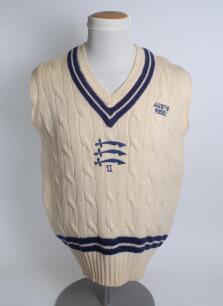 Middlesex white 2nd XI sleeveless sweater, by F.A.B. Knitwear, with trimming to collar and waist in club colours, Middlesex emblem and &lsquo;II&rsquo; to the centre and sponsors logo &lsquo;Austin Reed&rsquo; of chest. Size 44&rdquo;. Player unknown. Good condition