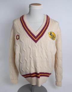 Northamptonshire white 1st XI long sleeved sweater, by Merlin, with trimming to collar and waist in club colours, Northamptonshire emblem and sponsors logo &lsquo;Dr Martens&rsquo; to chest. Size 48&rdquo;. Player unknown. Good condition