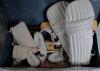 Derek Leslie Underwood. Kent & England 1963-1987. Two cricket coffins, one in brown decorated in M.C.C./ England colours with &lsquo;D. Underwood M.C.C. Team&rsquo; stencilled to lid. Luggage identity tag attached to handle with Underwood&rsquo;s name &lsquo;c/o International Wa - 5