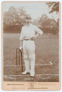 Edward Mark Sprot. Hampshire 1898-1914. Original sepia cabinet card photograph of Sprot, full length in batting attire and Hampshire cap, stood at the wicket. Name printed to lower edge of photograph. E. Hawkins & Co. of Brighton. Card measures 4.25&rdquo;x6.25