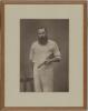 William Gilbert Grace. Large impressive sepia photograph of Grace, three quarter length, wearing cricket whites and holding a cricket bat under his arm. The photograph mounted, framed and glazed and overall 11&rdquo;x14&rdquo;. W&S Ltd. Barraud of Oxford Street, Lond