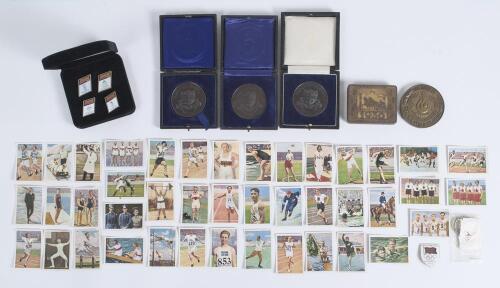 Olympic Games 1928-1996. Selection of collectors&rsquo; cards, medals, badges etc. Includes forty two German colour collectors&rsquo; cards for the 1928 Amsterdam Olympic Games. An unusual cigarette tin for the Olympic Games Berlin 1936 with &lsquo;1936&rsquo; and emblem to top 