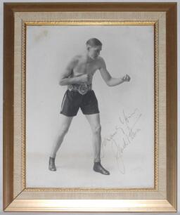 Jack Petersen. British and Empire (Commonwealth) Heavyweight Champion 1930s. Large original mono studio photograph of Peterson in boxing pose wearing his Lonsdale Belt. Nicely and boldly signed in gold ink by Peterson. Photographer&rsquo;s signature in pencil t