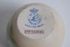 Carltonware stoneware circular match holder c.1906 printed with a colour illustration of two men playing golf and caddie holding the bag. Maker&rsquo;s stamp to base with registration no. 333948. 2.5&rdquo; tall, 2.75&rdquo; diameter. Good condition - 2