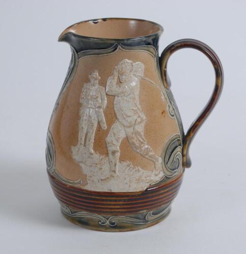 Royal Doulton Lambeth Golf jug. An attractive Royal Doulton Lambeth stoneware jug with strap handle, of bulbous form, with art nouveau design with scrolled foliate borders, enriched in green, blue and brown glazes, with three golfing scenes in white relie