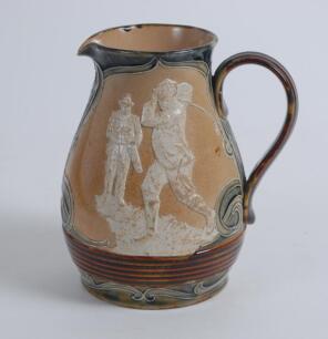 Royal Doulton Lambeth Golf jug. An attractive Royal Doulton Lambeth stoneware jug with strap handle, of bulbous form, with art nouveau design with scrolled foliate borders, enriched in green, blue and brown glazes, with three golfing scenes in white relie
