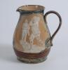 Royal Doulton Lambeth Golf jug. An attractive Royal Doulton Lambeth stoneware jug with strap handle, of bulbous form, with art nouveau design with scrolled foliate borders, enriched in green, blue and brown glazes, with three golfing scenes in white relie