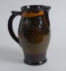 A large Royal Doulton Kingsware pitcher with a golf scene of cavalier golfer with caddie (Charles Crombie) to one side and a smaller group playing golf to verso. Royal Doulton mark to the bottom of the jug. 9&rdquo; tall. Circa 1930. Very good condition - 2