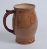 Royal Doulton &lsquo;Airbrush Brown&rsquo; Kingsware mug/tankard with a golf scene of cavalier golfer with caddie (Charles Crombie) to one side and a smaller group playing golf to verso. Royal Doulton mark and No. 5716 to the bottom of the mug. 5.5&rdquo; tall. Circa 1930 - 2