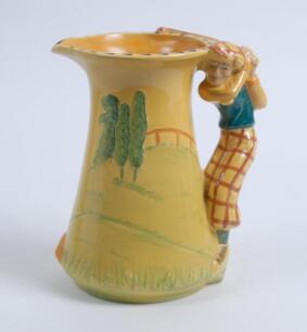 Burleigh Ware &lsquo;Golfer&rsquo; jug of tapering shape with handle moulded as a golfer playing a shot, the jug with a golf course painted in colours against a bright yellow ground, 7.75&rdquo;, This is a reproduction of the 1930&rsquo;s pieces made in 2000 by Burgess Dorling a