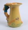 Burleigh Ware &lsquo;Golfer&rsquo; jug of tapering shape with handle moulded as a golfer playing a shot, the jug with a golf course painted in colours against a bright yellow ground, 7.75&rdquo;, This is a reproduction of the 1930&rsquo;s pieces made in 2000 by Burgess Dorling a - 2