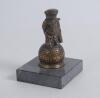 &lsquo;Golf counter bell. A cast brass counter bell in the form of a comical figure of a golf caddie with a golf ball for his head, standing on a larger golf ball. It dates to approximately the 1940/50s and was designed by the popular artist John Hassall in the