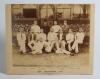 &lsquo;The Australians 1884&rsquo;. Original sepia photograph of the Australian team who played Lord Sheffield&rsquo;s Eleven at Sheffield Park, East Sussex on the 12-14th May 1884, standing and seated in rows wearing blazers, caps and cricket attire. The photograph laid d