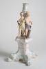 Cricket themed candlestick. Large ceramic candlestick the centre features two winged cherubs holding cricket bats on plinth, the base with four feet. A very colourful design in pastel coloured glaze in pink, light blue, mauve and yellow with gilt lustre. - 2