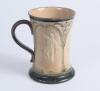 Doulton Lambeth stoneware waisted ceramic tankard with three moulded relief vignettes of cricketers, a batsman, bowler and wicket keeper in white on brown background. With stylised floral leaf and flower decoration to top and beneath in green, brown and l - 3