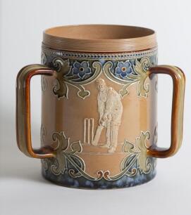 Doulton Lambeth stoneware tyg. Large, than normal, and impressive three handled tyg with three moulded relief vignettes of cricketers, a batsman, a fielder and wicket keeper in white on a green cameo background with blue circular surround, the sides highl
