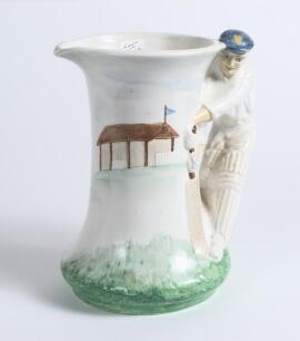 Burleigh Ware &lsquo;style&rsquo; art deco ceramic cricket jug. The jug based on the 1930&rsquo;s original with cricket field and pavilion design to body with &lsquo;batsman&rsquo; handle in white and green was produced in 2000 by Burgess, Dorling and Leigh, Burslem, near Stoke on Tre