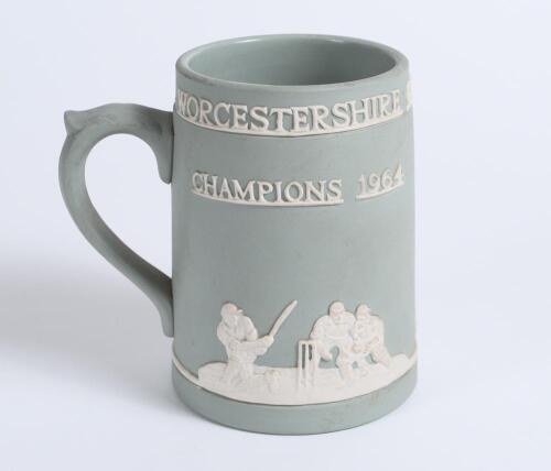 &lsquo;Worcestershire County Cricket Club. Champions 1964&rsquo;. Jasperware 5&rdquo; green/grey ceramic tankard produced to commemorate the Championship win. With raised figures of a bowler, batsman, fielders, the Cathedral and the County emblem in white. Sold with small 