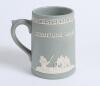 &lsquo;Worcestershire County Cricket Club. Champions 1964&rsquo;. Jasperware 5&rdquo; green/grey ceramic tankard produced to commemorate the Championship win. With raised figures of a bowler, batsman, fielders, the Cathedral and the County emblem in white. Sold with small 