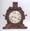 Cricket clock circa late 19th early 20th Century. Very large and impressive Victorian/ Edwardian clock with plain circular face set in an ornate heavy oak wooden frame consisting of carved floral border set on a background of crossed cricket bats, stumps 