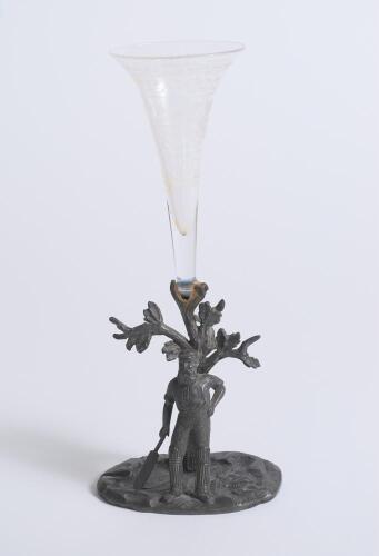 W.G. Grace c1896. Electroplated tulip vase cast with a figure of Grace standing with bat in front of a filigree tree in Art Nouveau style. Stamped &lsquo;W.W.H. & Co&rsquo; (W.W. Harrison & Co, Sheffield) to base. 5.5&rdquo; tall. With glass flute, which appears to be orig
