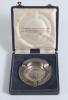 England v Australia 1861-1961&rsquo;. Hallmarked silver ashtray with England and Australian emblems to centre and wording England v Australia 1861-1961&rsquo; to borders. In original presentation box which has titles to lid. G