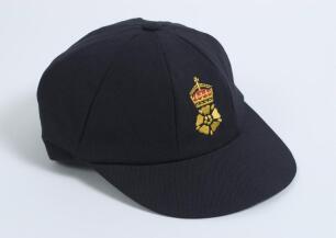 Robert William &lsquo;Bob&rsquo; Taylor. Derbyshire & England 1961-1988. Derbyshire C.C.C. 1st XI navy blue cricket cap with embroidered Derbyshire emblem of the royal crown and tudor rose to front. &lsquo;Bob Taylor&rsquo; handwritten to inside label of the cap. The cap elastic
