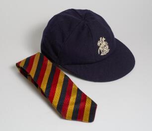 Robert William &lsquo;Bob&rsquo; Taylor. Derbyshire & England 1961-1988. M.C.C. touring Test cap and tie issued to Taylor during his playing career. The navy blue cap with central emblem of St. George & the Dragon to front. &lsquo;R.W. Taylor&rsquo; handwritten to inner label. V
