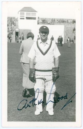 Arthur Wood. Yorkshire & England 1927-1948. Mono real photograph plain back postcard of Wood standing full length wearing wicket-keeping attire on the outfield at Scarborough in 1935. Very nicely signed in ink by Wood to the photograph. Official stamp to 