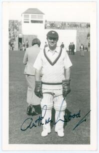 Arthur Wood. Yorkshire & England 1927-1948. Mono real photograph plain back postcard of Wood standing full length wearing wicket-keeping attire on the outfield at Scarborough in 1935. Very nicely signed in ink by Wood to the photograph. Official stamp to 