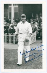 Thomas Frank Smailes. Yorkshire & England 1932-1948. Mono real photograph plain back postcard of Smailes, full length walking out to bat at Scarborough in 1936. Very nicely signed in blue ink with dedication by Smailes to the photograph. Official stamp to
