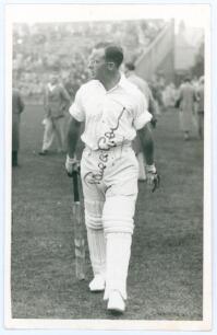 Paul Anthony Gibb. Yorkshire, Cambridge University, Essex & England 1935-1956. Mono real photograph plain back postcard of Gibb, full length wearing batting attire on the outfield at Scarborough in 1938. Very nicely signed in ink by Gibb to the photograph