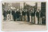Kent at Herne Bay 1932. Mono real photograph postcard of the players congregated together at the entrance to the ground, all wearing cricket attire and blazers. Inscription in ink to verso describes &lsquo;Herne Bay C.C. v full Kent XI, May 1932. Group includes