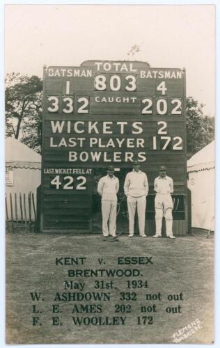 &lsquo;Kent v. Essex, Brentwood May 31st 1934&rsquo;. Record score. Sepia real photograph postcard depicting Bill Ashdown, Les Ames and Frank Woolley standing in front of the scoreboard, Kent having recorded their record County Championship score of 803 for four wick