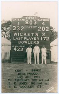 &lsquo;Kent v. Essex, Brentwood May 31st 1934&rsquo;. Record score. Sepia real photograph postcard depicting Bill Ashdown, Les Ames and Frank Woolley standing in front of the scoreboard, Kent having recorded their record County Championship score of 803 for four wick