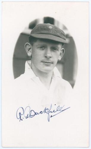 Richard George &lsquo;Dick&rsquo; Duckfield. Glamorgan 1930-1938. Mono real photograph postcard of Duckfield in cameo, head and shoulders wearing cricket attire and Glamorgan cap. Nicely signed in blue ink to the lower border by Duckfield. Official stamp to verso for