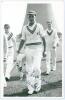 Keith Robert Dollery. Queensland, Auckland, Tasmania & Warwickshire 1947-1956. Mono real photograph plain back postcard of Dollery, full length walking off the field wearing cricket attire. Nicely signed in blue ink to the photograph by Dollery. Appears t