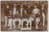 Gloucestershire 1904. Early sepia real photograph postcard of the Gloucestershire team for the match v Sussex at Hove, 23rd- 25th May 1904. Players depicted seated and standing in rows wearing blazers, caps, boaters, include Jessop (Captain), Thomas, Gods