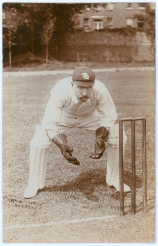 Arthur Frederick Augustus &lsquo;Dick&rsquo; Lilley. Warwickshire & England 1894-1911. Early sepia real photograph postcard of Lilley full length crouched in wicket-keeping pose wearing an England cap. E. Hawkins & Co. of Brighton. Player&rsquo;s name and photographer ligh