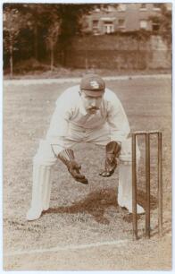 Arthur Frederick Augustus &lsquo;Dick&rsquo; Lilley. Warwickshire & England 1894-1911. Early sepia real photograph postcard of Lilley full length crouched in wicket-keeping pose wearing an England cap. E. Hawkins & Co. of Brighton. Player&rsquo;s name and photographer ligh