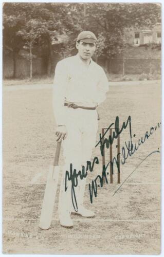 William Herbert Wilkinson. Yorkshire 1903-1910. Early sepia real photograph postcard of Wilkinson standing full length at the wicket leaning on his bat wearing a Yorkshire cap. E. Hawkins & Co., Brighton. Boldly signed to the photograph in black ink by Wi