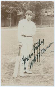 William Herbert Wilkinson. Yorkshire 1903-1910. Early sepia real photograph postcard of Wilkinson standing full length at the wicket leaning on his bat wearing a Yorkshire cap. E. Hawkins & Co., Brighton. Boldly signed to the photograph in black ink by Wi