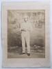 Edward Mills Grace. Gloucestershire, M.C.C. & England 1870-1896. Early large original sepia studio posed photograph of Grace in full cricket attire and wearing a cap, aged 21. The photograph, taken in 1862, shows Grace standing in front of a wicket holdin