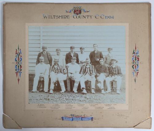 &lsquo;Wiltshire County C.C. 1904. Winners of Minor Counties Championship&rsquo;. Original mono photograph of the Wiltshire team seated and standing in rows wearing cricket attire and assorted blazers and headgear. The photograph by Heath & Bradnee of Exeter measures
