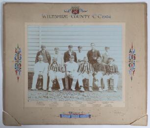 &lsquo;Wiltshire County C.C. 1904. Winners of Minor Counties Championship&rsquo;. Original mono photograph of the Wiltshire team seated and standing in rows wearing cricket attire and assorted blazers and headgear. The photograph by Heath & Bradnee of Exeter measures