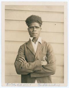 Edward &lsquo;Eddie&rsquo; Gilbert. Queensland 1930-1936. Original sepia candid-style photograph of Gilbert, standing three quarter length wearing cricket attire and Queensland blazer. 3.5&rdquo;x4.25&rdquo;. Photographer unknown. Name annotated in ink to lower margin. Good/ ver
